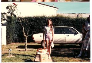 Amy playing with her doll in the front yard of our house 192